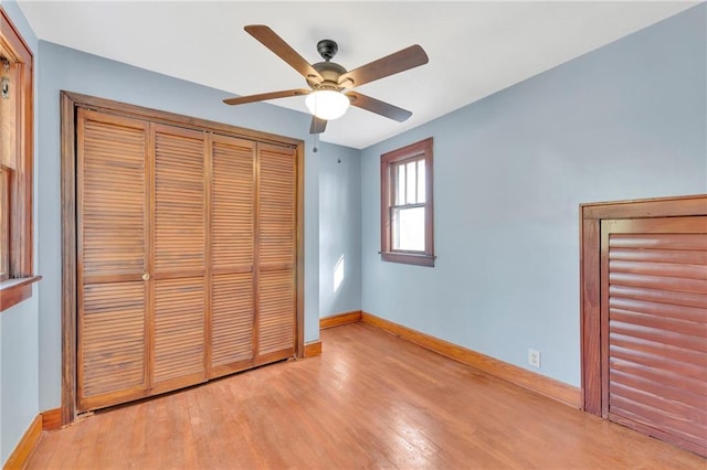 unfurnished bedroom featuring a closet, light wood-type flooring, and ceiling fan