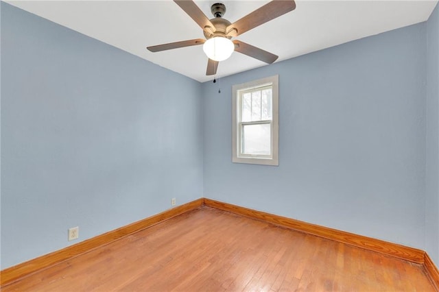 spare room featuring hardwood / wood-style floors and ceiling fan