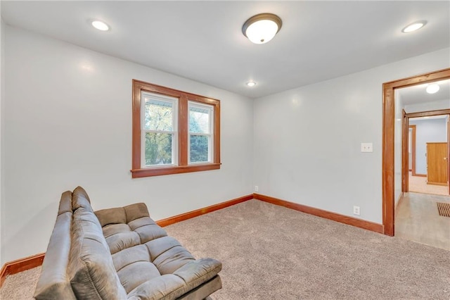 sitting room featuring light carpet