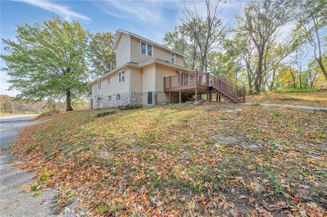 back of property featuring a wooden deck