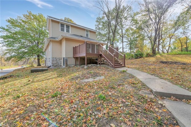 back of house featuring a wooden deck