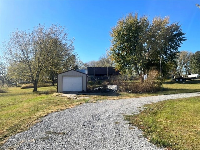 exterior space featuring a front yard, an outdoor structure, and a garage