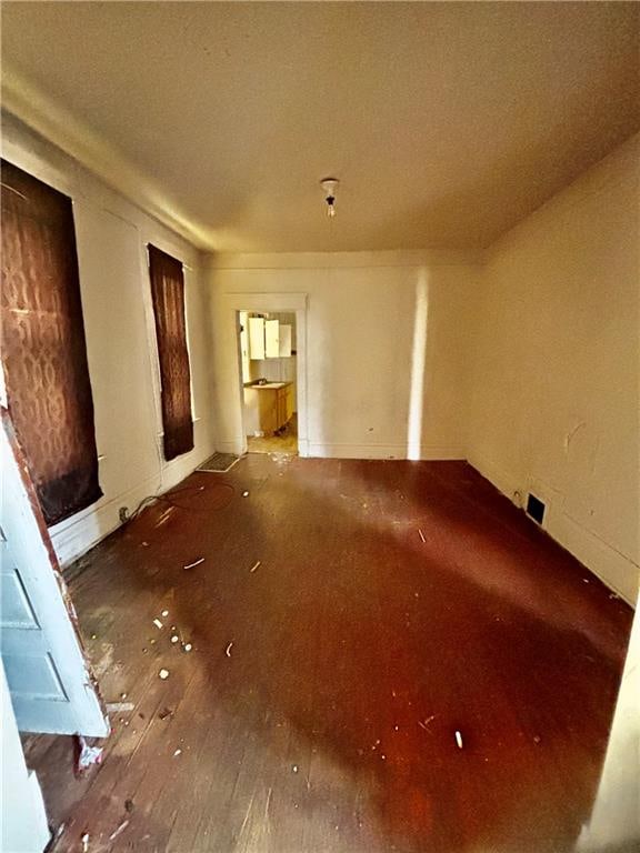 empty room with hardwood / wood-style flooring and a textured ceiling