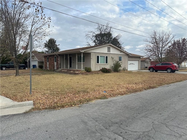 single story home featuring a garage and a front yard