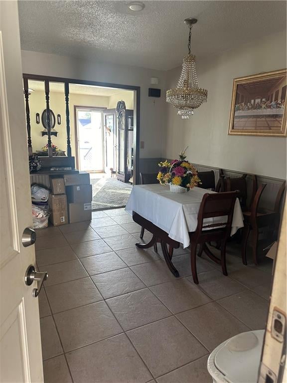 dining space with tile patterned flooring and a textured ceiling