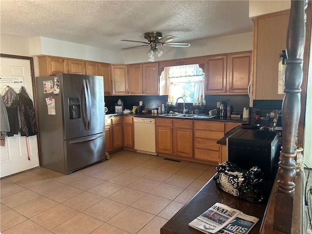 kitchen featuring light tile patterned flooring, stainless steel refrigerator with ice dispenser, ceiling fan, a textured ceiling, and dishwasher