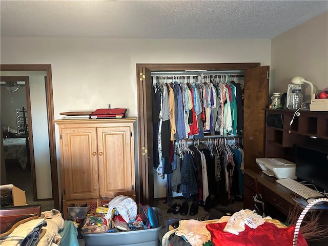 bedroom featuring a textured ceiling and a closet