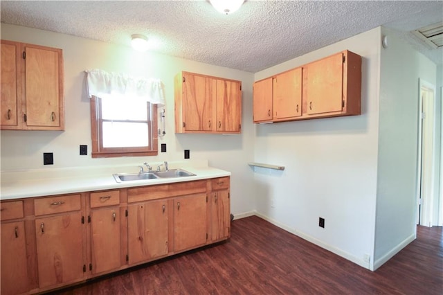 kitchen featuring dark hardwood / wood-style floors, sink, and a textured ceiling