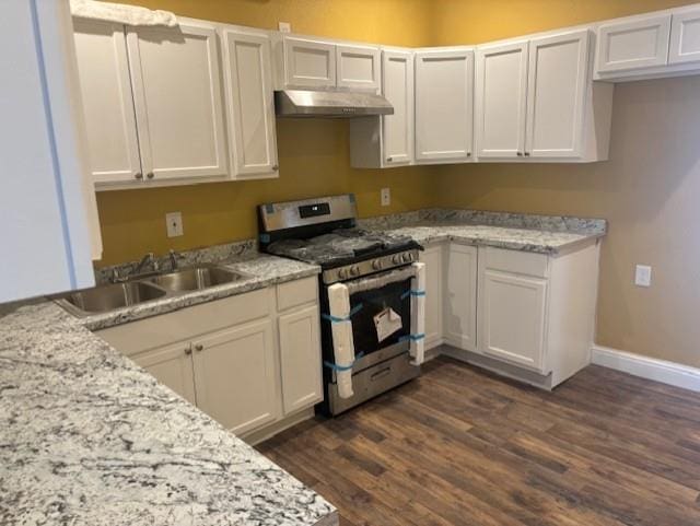 kitchen featuring light stone countertops, sink, white cabinets, stainless steel gas range, and dark hardwood / wood-style floors