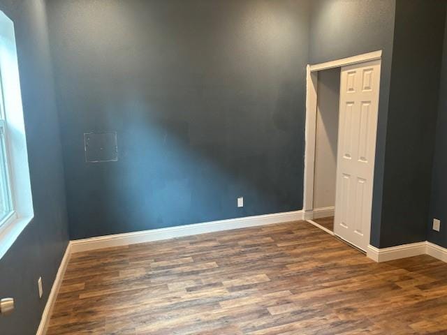 empty room featuring dark wood-type flooring