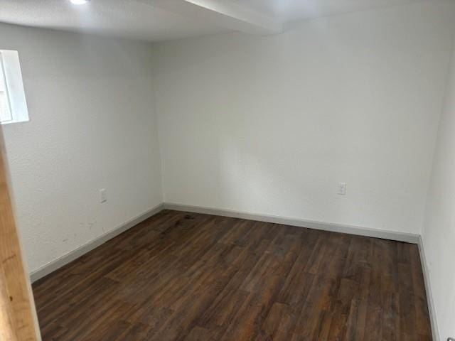 unfurnished room featuring dark wood-type flooring