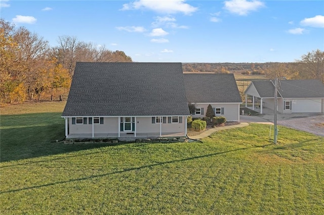 view of front facade with a front yard and covered porch