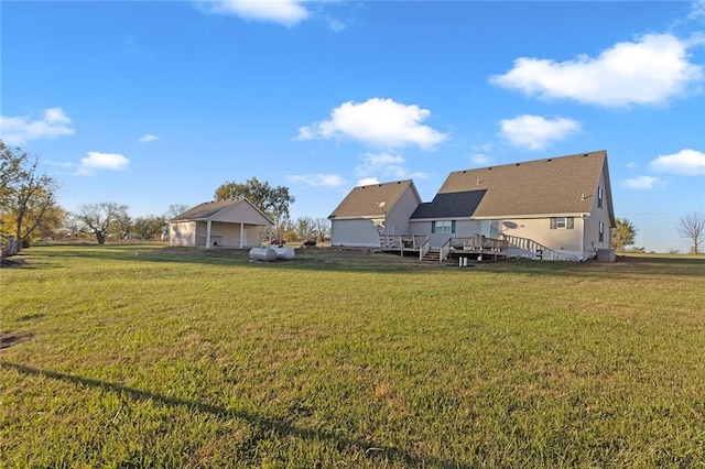 view of yard with a wooden deck and a garage