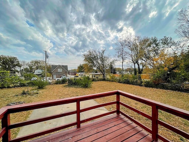 wooden terrace with a lawn