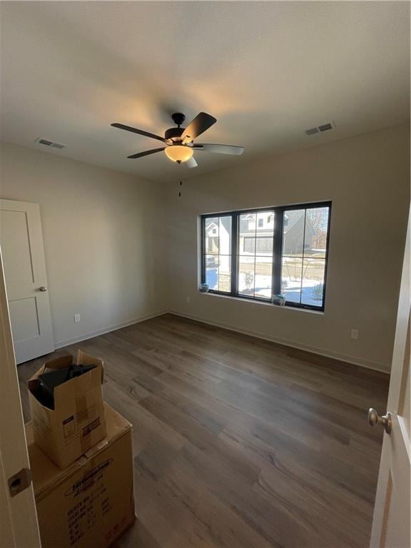 empty room featuring ceiling fan and wood-type flooring