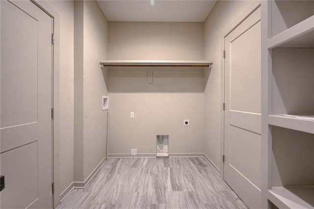 laundry area with baseboards, hookup for an electric dryer, laundry area, and hookup for a washing machine