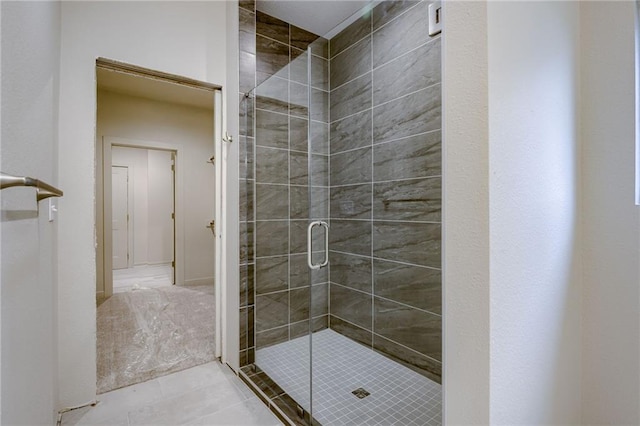 full bathroom featuring tile patterned floors and a shower stall