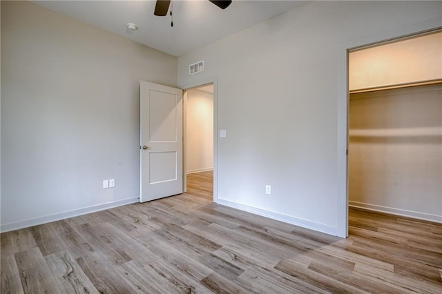 unfurnished bedroom featuring visible vents, baseboards, and wood finished floors