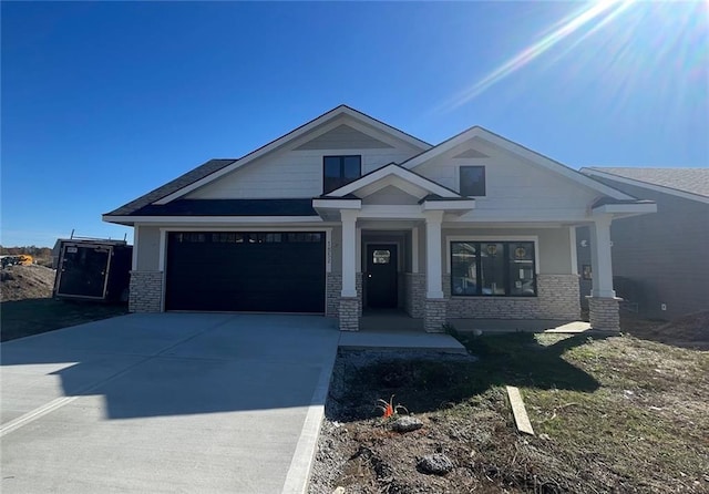 craftsman-style home featuring a porch and a garage