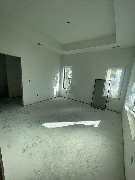 spare room featuring a raised ceiling