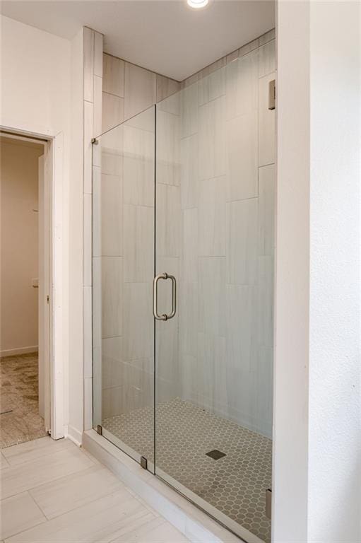 bathroom featuring tile patterned floors and a stall shower
