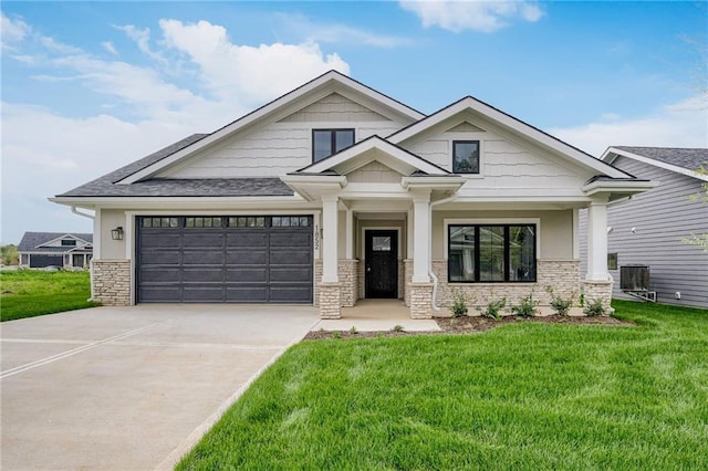 craftsman inspired home featuring stone siding, driveway, and a front yard