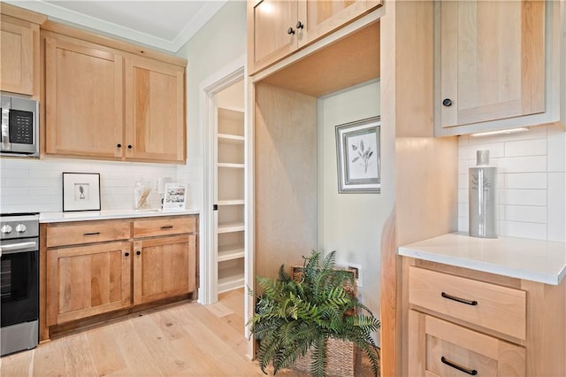 kitchen with tasteful backsplash, light hardwood / wood-style flooring, light brown cabinets, ornamental molding, and appliances with stainless steel finishes