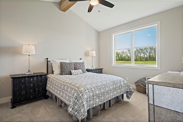 carpeted bedroom with ceiling fan and vaulted ceiling with beams