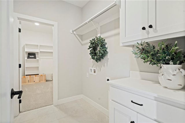 laundry area with cabinets, hookup for a washing machine, light carpet, and electric dryer hookup