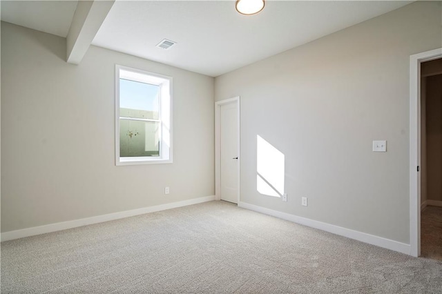 carpeted spare room featuring plenty of natural light