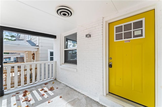 view of exterior entry with a porch