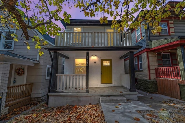 view of front of house featuring covered porch and a balcony