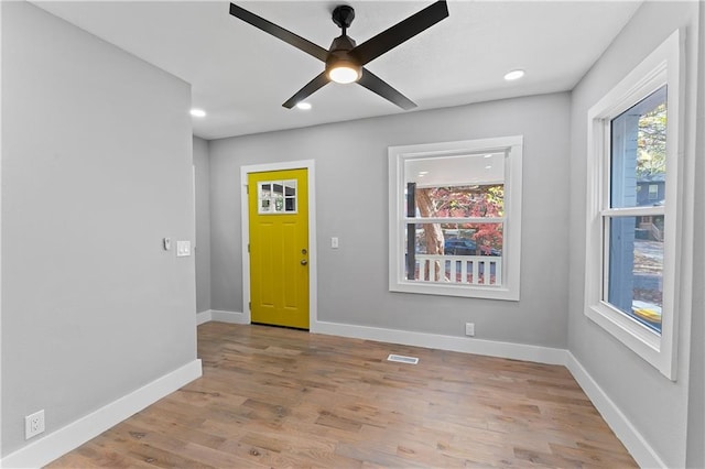 foyer entrance with light hardwood / wood-style floors and ceiling fan