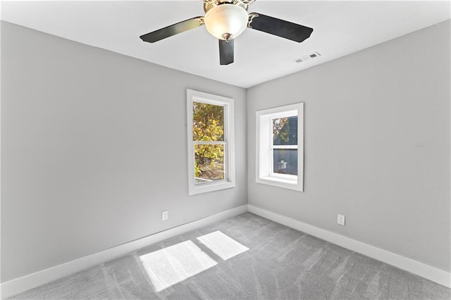 carpeted spare room with ceiling fan