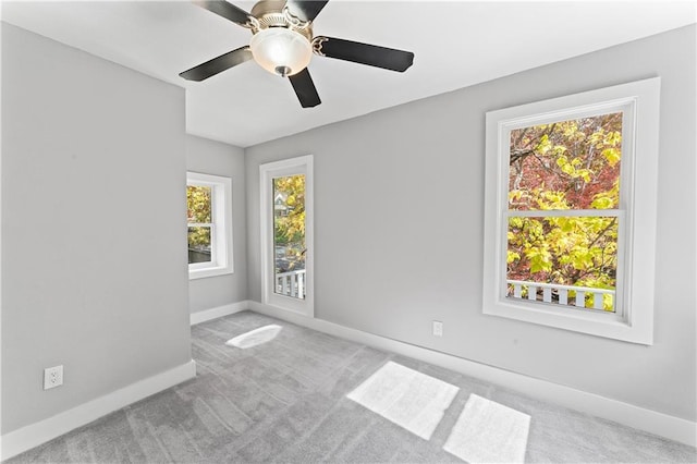 carpeted spare room with ceiling fan