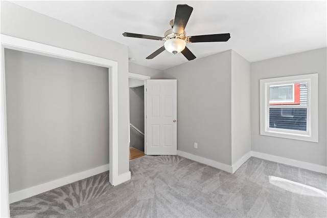 unfurnished bedroom with ceiling fan and light carpet