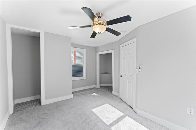 unfurnished bedroom with light colored carpet and ceiling fan