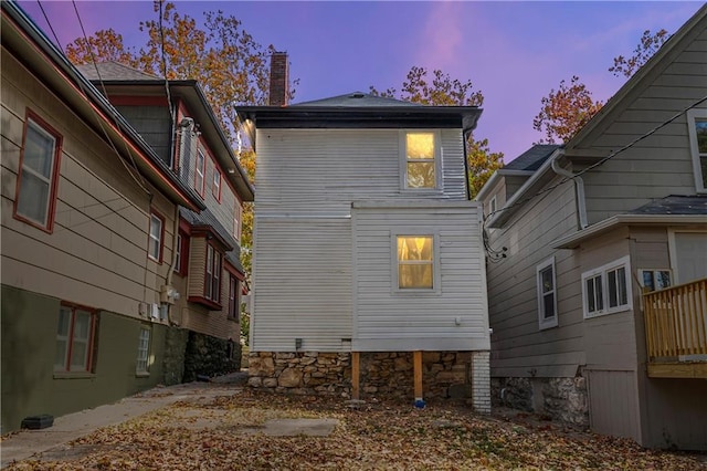 view of back house at dusk