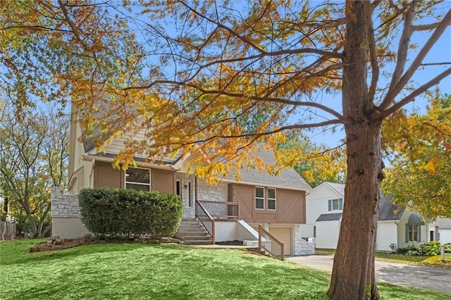 view of front of property featuring a garage and a front lawn