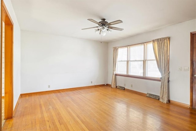 spare room featuring light wood-type flooring and ceiling fan