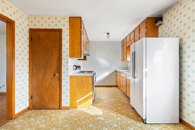 kitchen with range with electric cooktop and white refrigerator