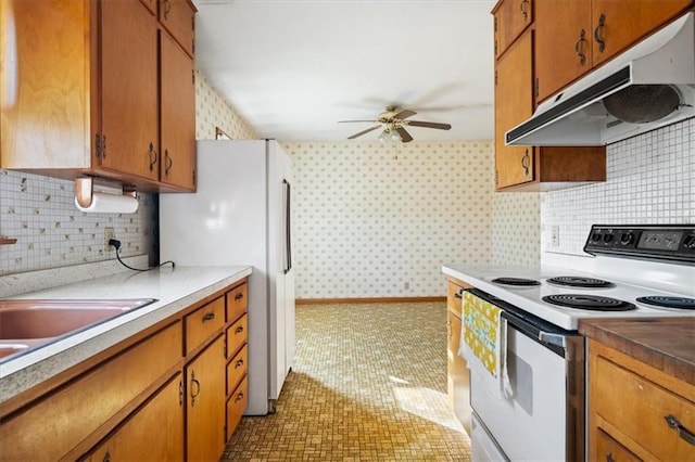 kitchen featuring light tile patterned floors, ceiling fan, white appliances, and tasteful backsplash