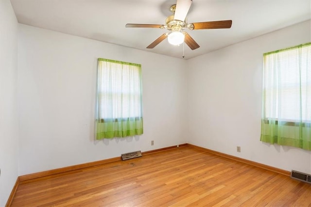 unfurnished room with ceiling fan, light hardwood / wood-style floors, and plenty of natural light