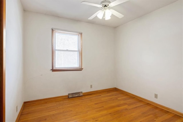 spare room featuring light hardwood / wood-style floors and ceiling fan