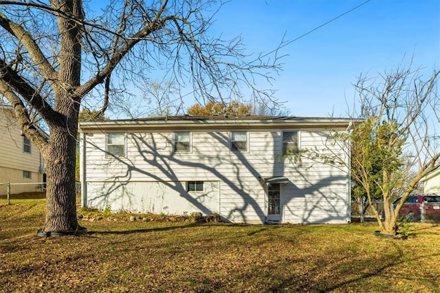 view of side of home with a yard