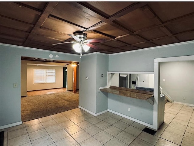 kitchen with ornamental molding, light colored carpet, coffered ceiling, and ceiling fan