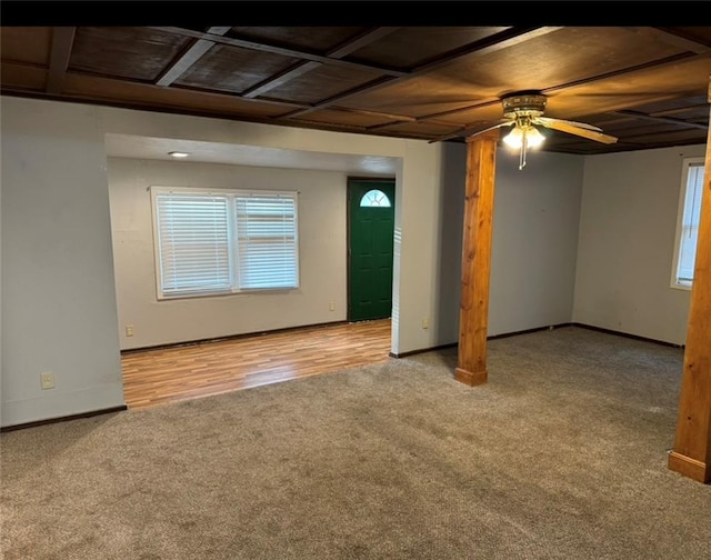 basement with light hardwood / wood-style floors, a healthy amount of sunlight, and ceiling fan