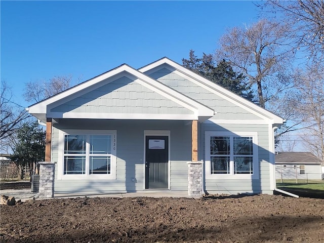 view of front facade with covered porch and central AC