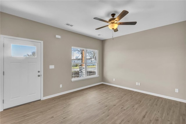 foyer with ceiling fan and light wood-type flooring