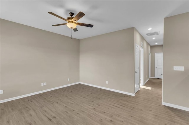 spare room featuring ceiling fan and light wood-type flooring